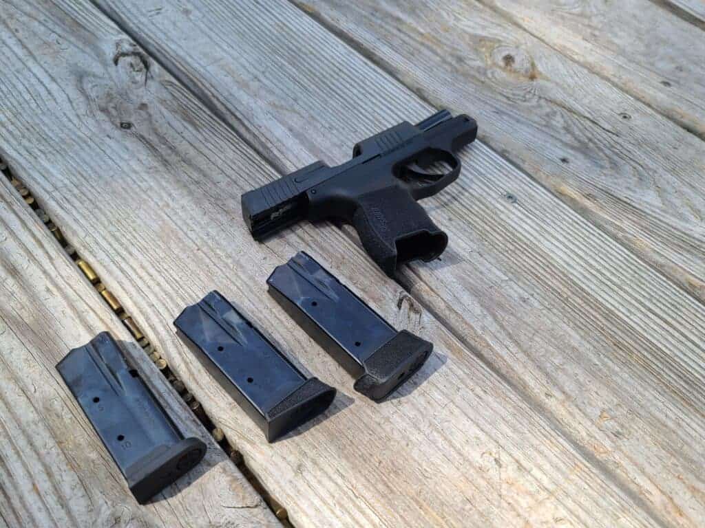 pistol and magazines on a deck